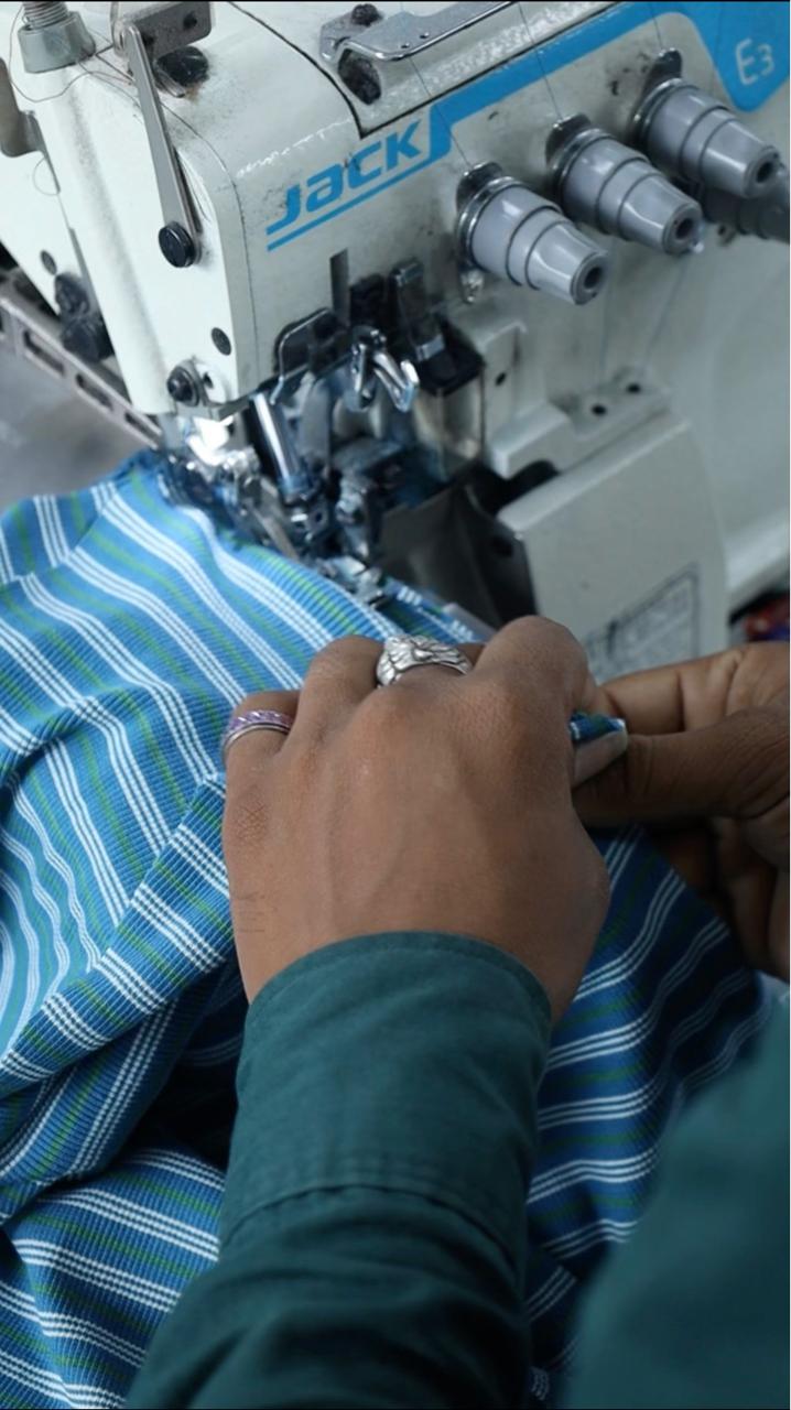 Artisan inspecting organic cotton fabric at Go Organnic manufacturing facility